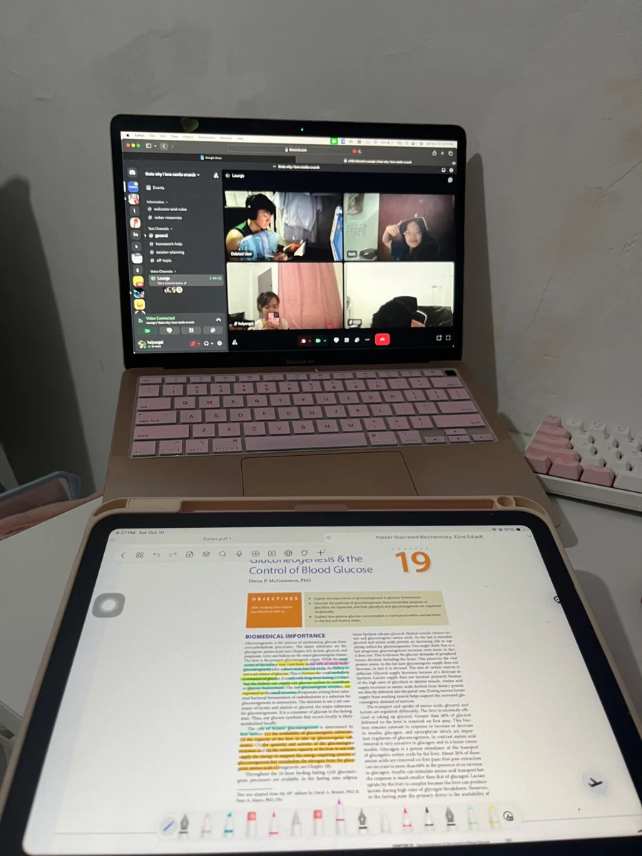 Online study session on a laptop with handwritten Biochemistry notes